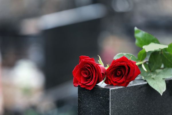 roses on a grave at a funeral for someone whose family needs to call our Wrongful Death Attorney In Atlanta